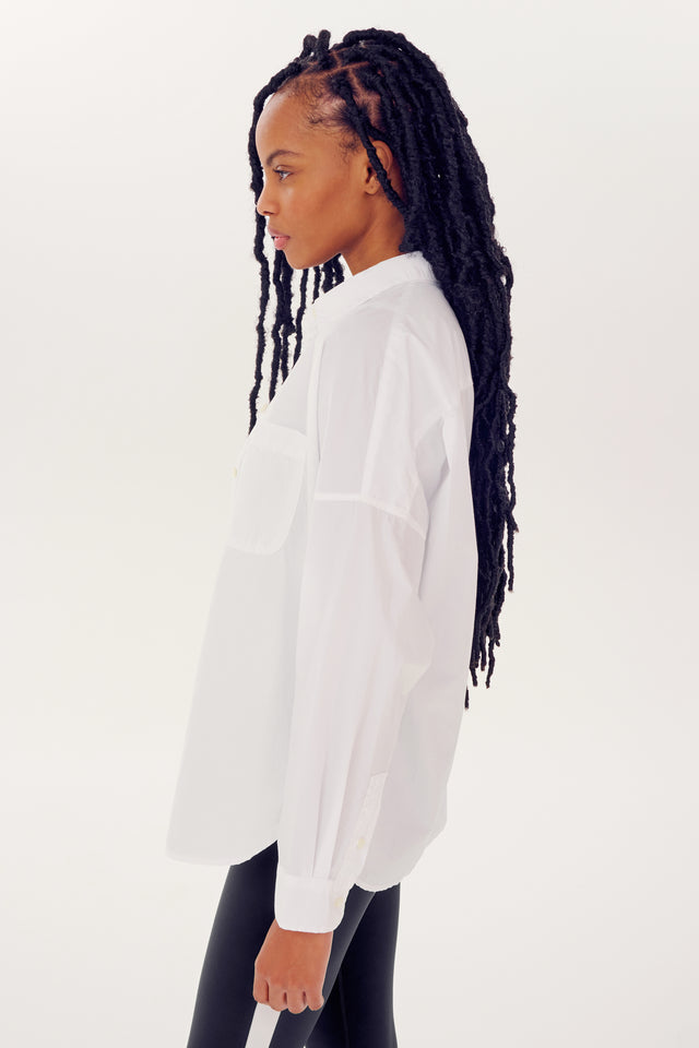 Woman in an oversized Alex Mill x Splits59 Jo Shirt - White standing in profile.