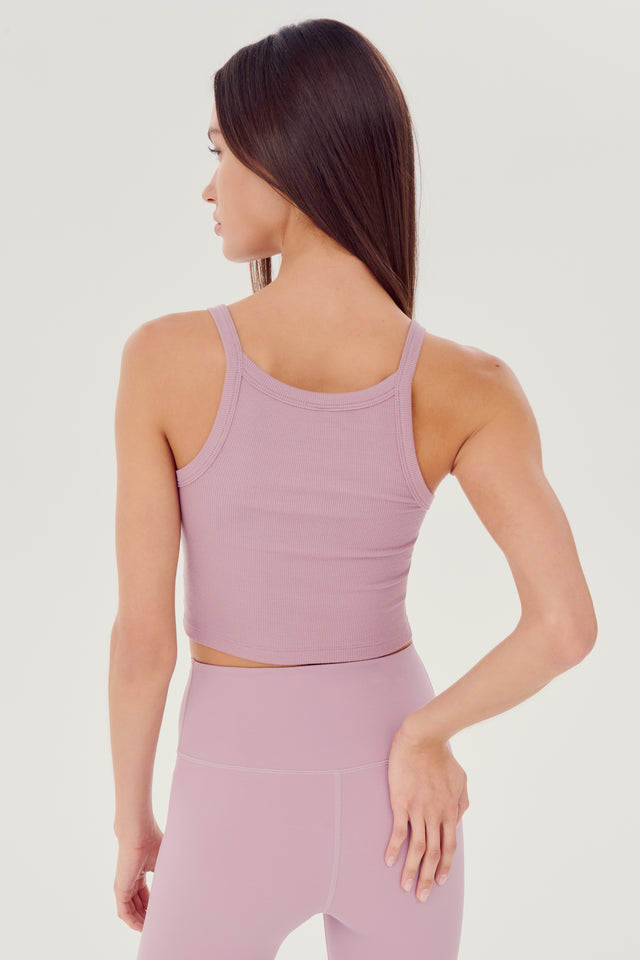 Back view of girl wearing light pink ribbed square neck cropped tank top with light pink leggings