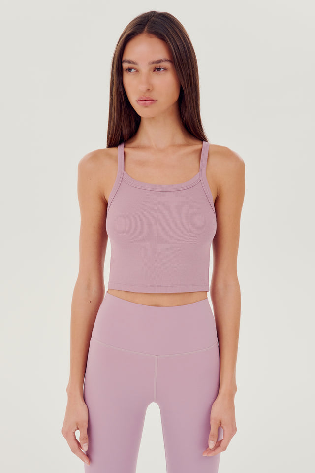 Front view of girl wearing light pink ribbed square neck cropped tank top with light pink leggings 