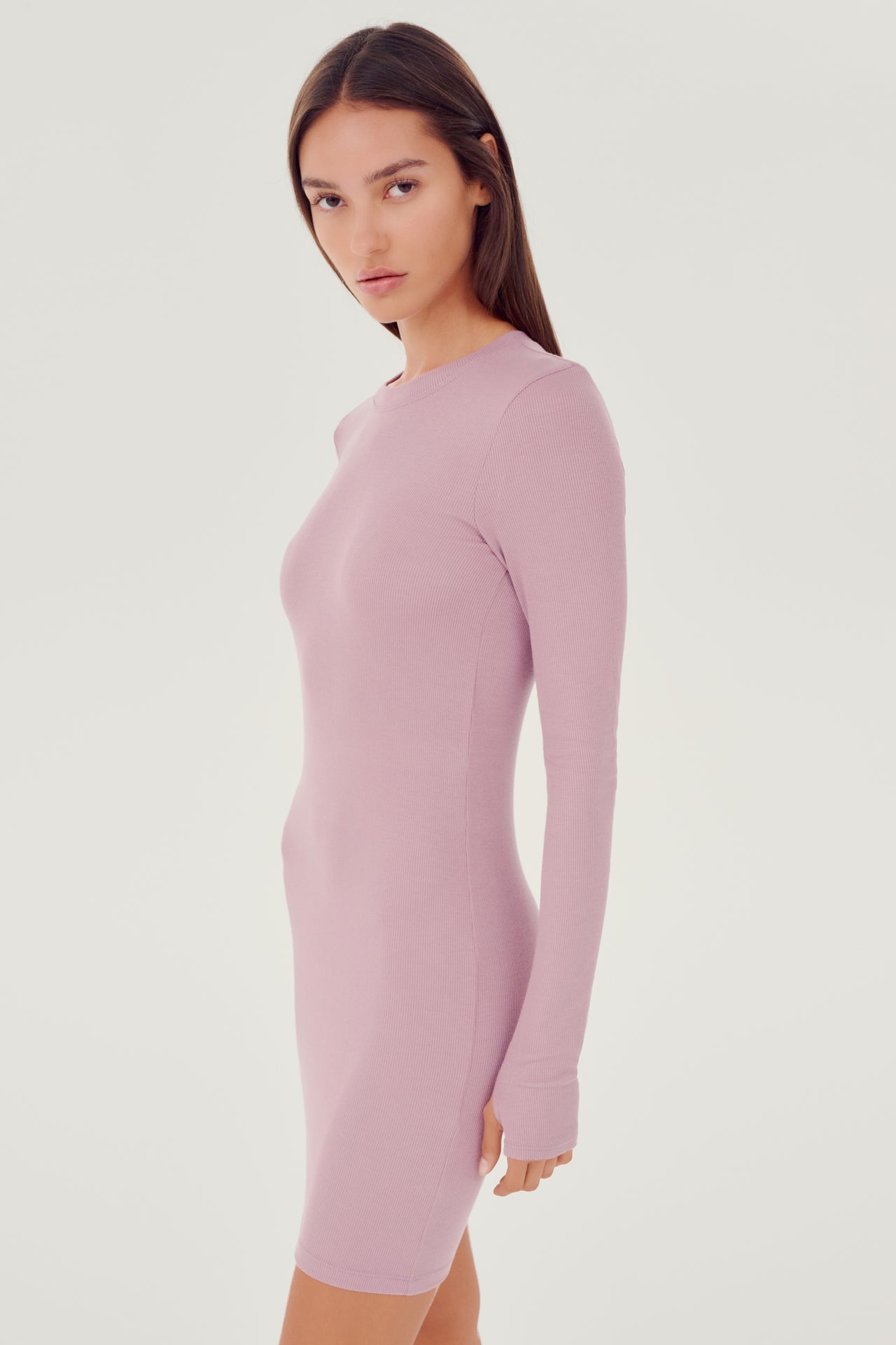 The model is wearing a Louise Rib Long Sleeve Dress in Blush by SPLITS59.