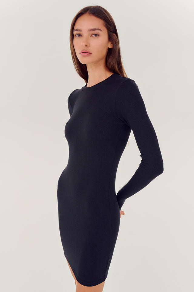 The model is wearing a SPLITS59 Louise Rib Long Sleeve Dress in black.