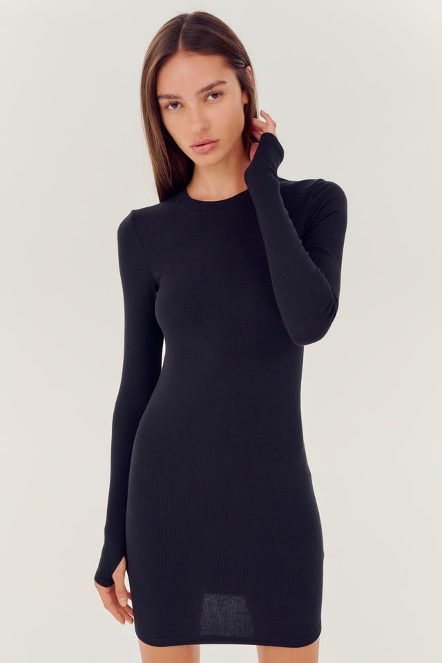 The model is wearing a SPLITS59 Louise Rib Long Sleeve Dress in Black.