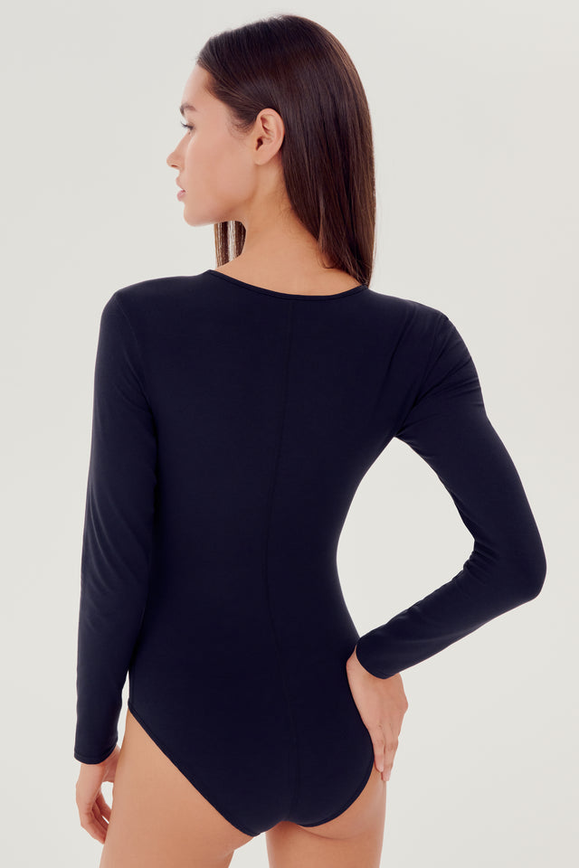 Back view of girl wearing black long sleeve one piece