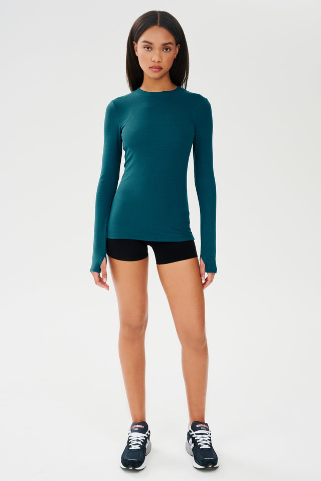 The SPLITS59 Louise Rib Long Sleeve - Peacock is teal and made from spandex and modal.