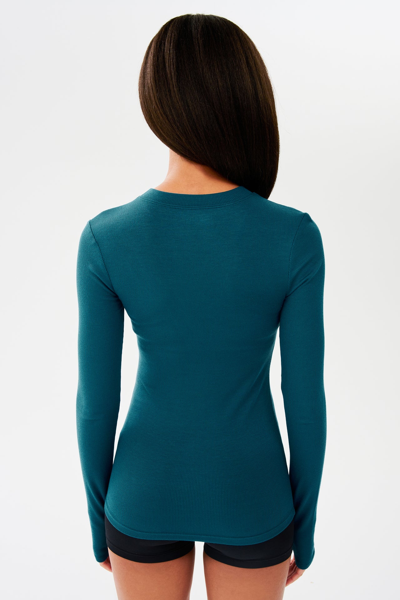 The back view of a woman wearing a SPLITS59 Louise Rib Long Sleeve - Peacock made of modal and spandex.