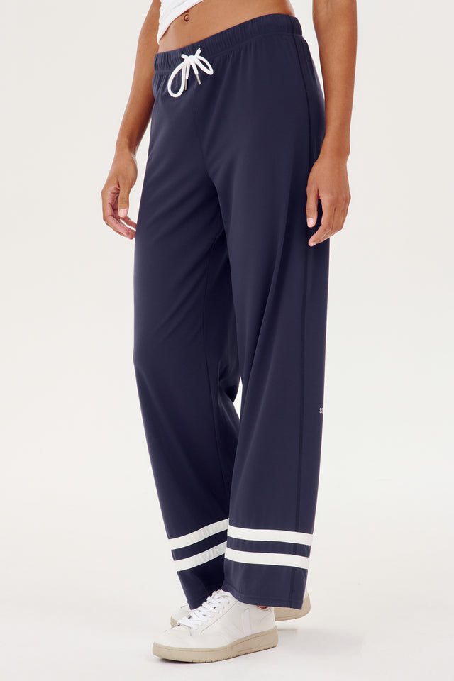 A woman wearing comfortable SPLITS59 Quinn Airweight Wide Leg Pant - Indigo with white stripes for yoga.