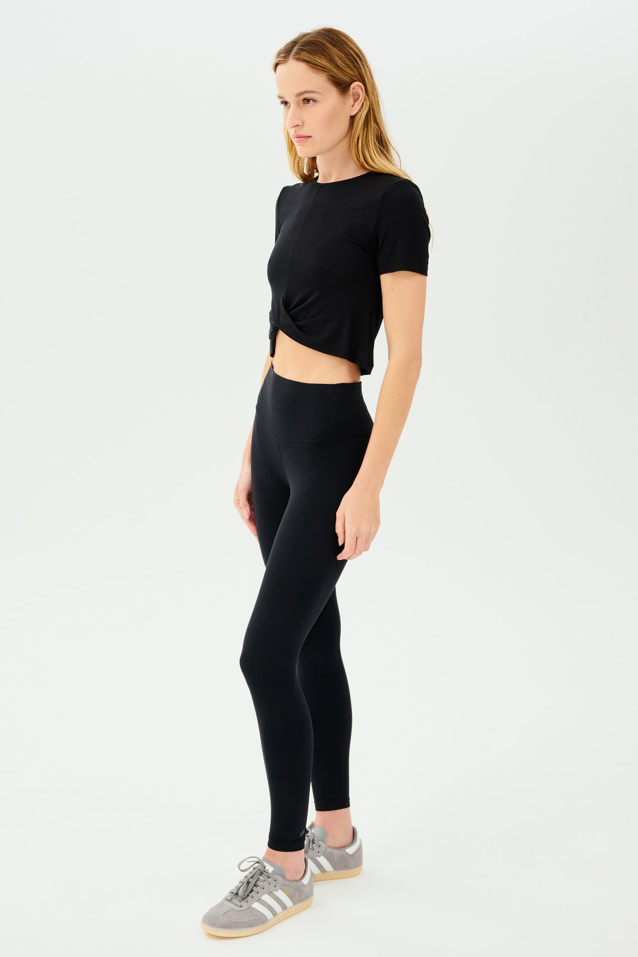 A woman wearing high waist leggings and a SPLITS59 Daisy Jersey Tee - Black.
