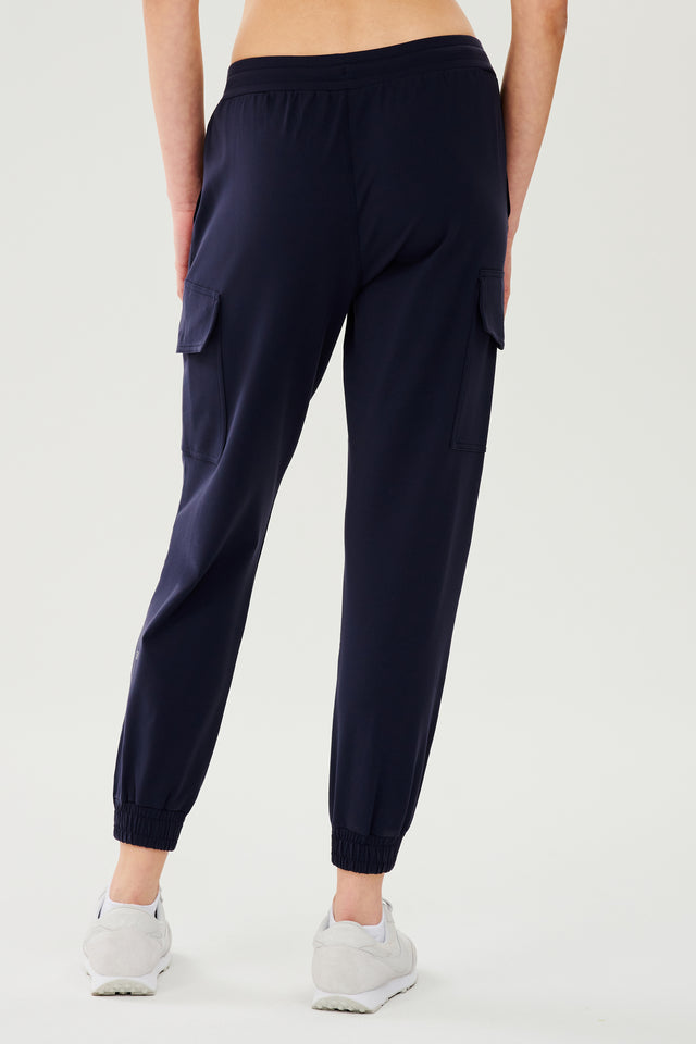 Back view of dark blue cargo pants with white shoes