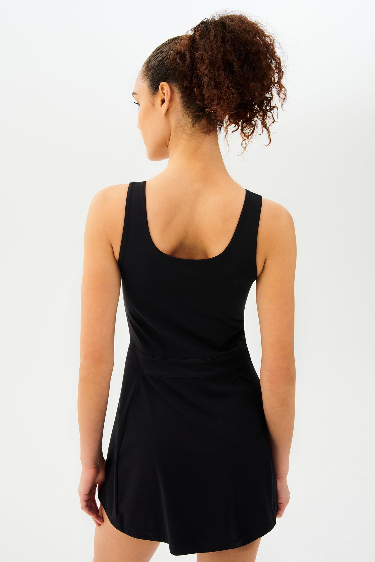 The back view of a woman wearing a SPLITS59 Martina Rigor Dress in Black.