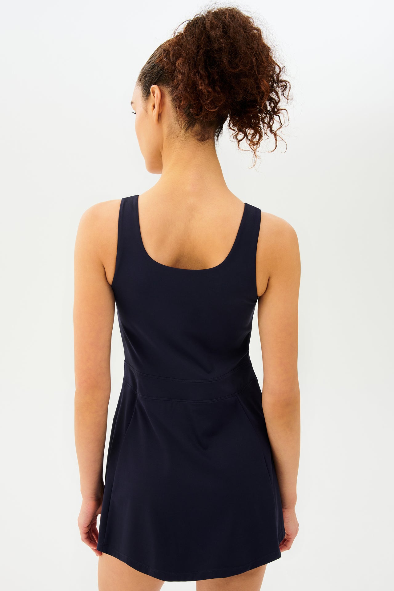 The back view of a woman in the Martina Rigor Dress by SPLITS59 made of Rigor fabric.