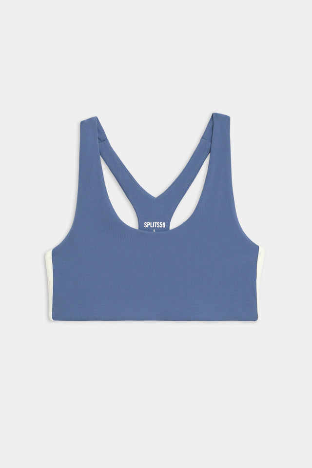 Flat view of light blue sports bra with thin black and white stripes down the side
