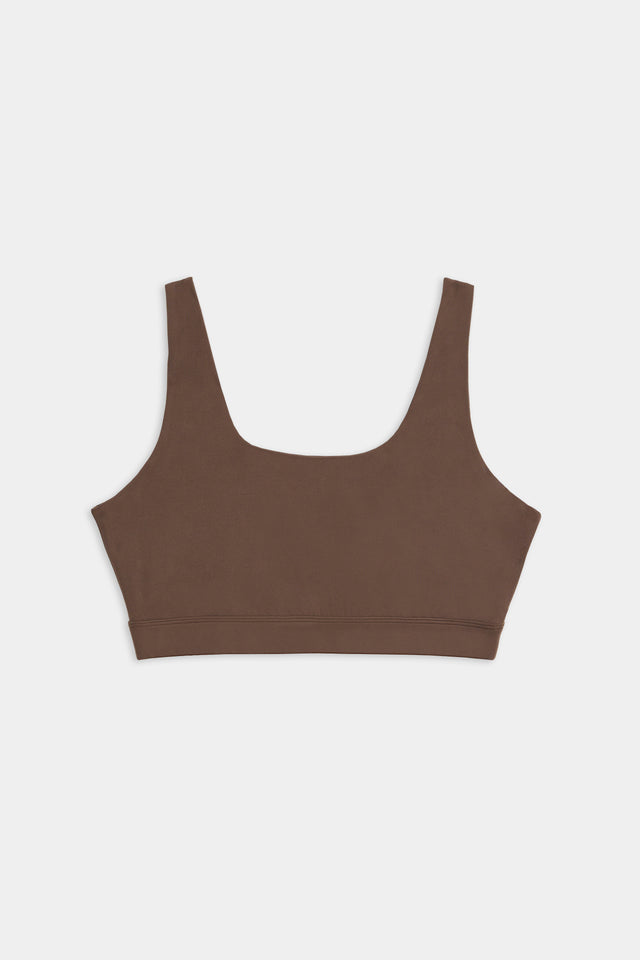 A brown sports bra made from a blend of spandex and nylon, featuring wide shoulder straps and a square neckline, set against a white background. The product is the Sprint Rigor Bra - Dark Chocolate by SPLITS59.