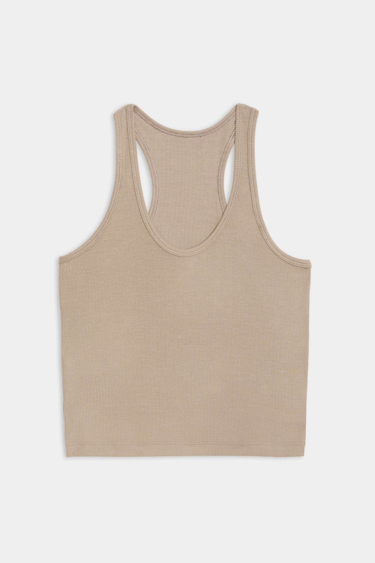 A beige, ribbed tank top crafted from a soft modal fabric with a hint of spandex for stretch, featuring a racerback design: the Ashby Rib Crop - Latte by SPLITS59.