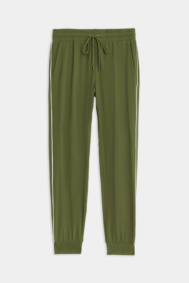 SPLITS59's Airweight Jogger 7/8 with Piping - Olive/White features a drawstring waistband, side pockets, white stripe accents, and ribbed cuffs made from a soft nylon fabric.