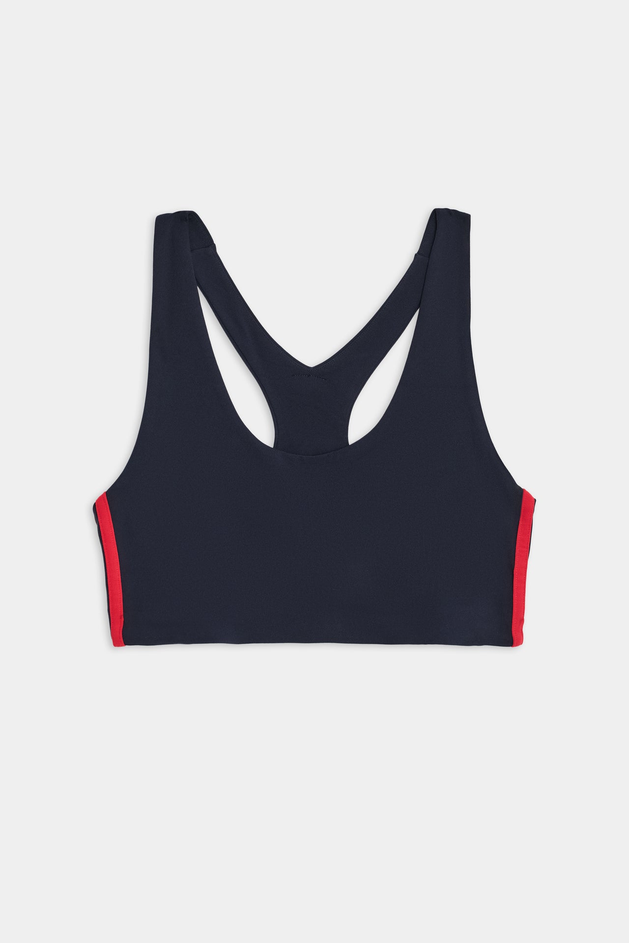 Front view of a SPLITS59 Ella Airweight Bra - Indigo/Pirate Red with red side panels, crafted from a nylon and spandex blend, featuring a racerback design on a white background.