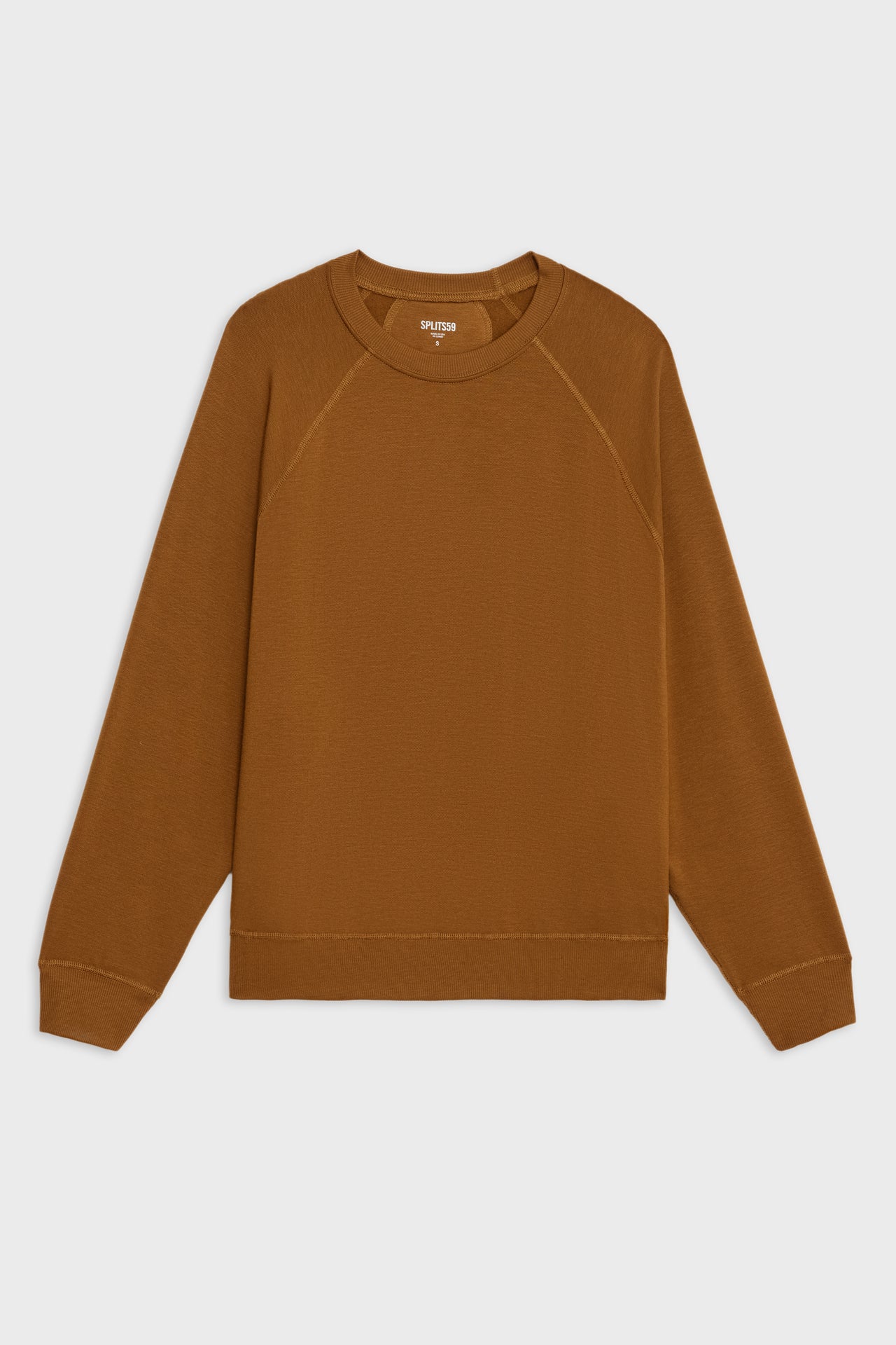 Flat view of girl wearing redish brown sweatshirt with visible stitching and ribbed hem