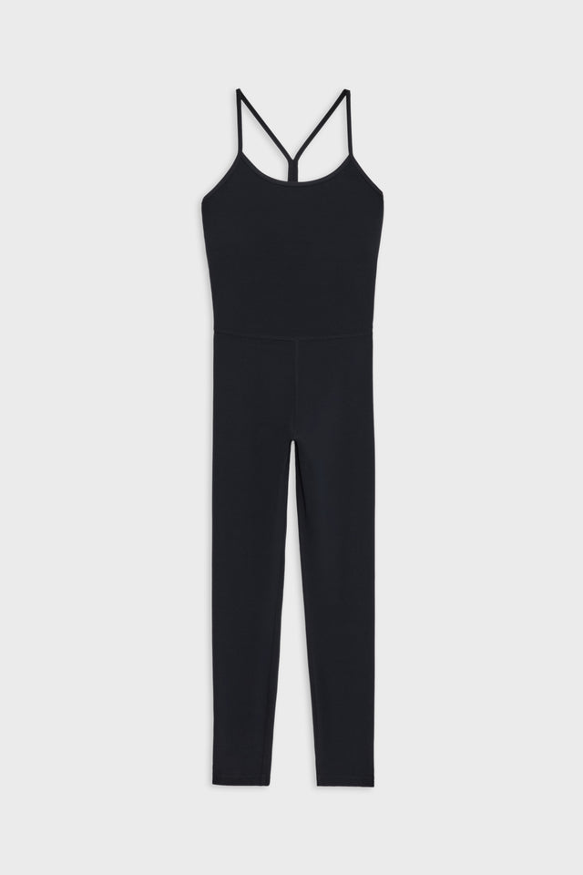 Flat view of a black jumpsuit with leggings, a white stripe along the side 