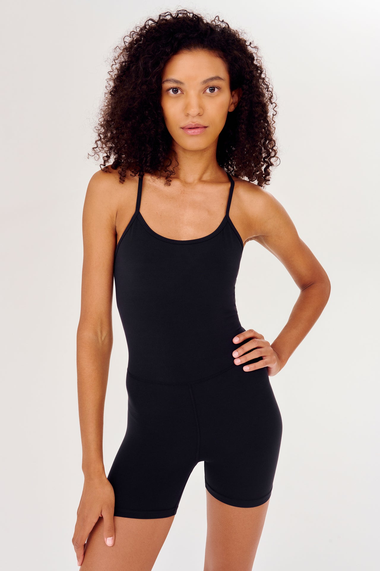 Full front view of black high thigh spaghetti strap body suit/one piece