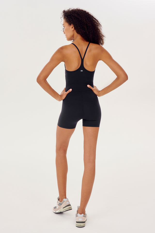 Full back view of black high thigh spaghetti strap body suit/one piece
