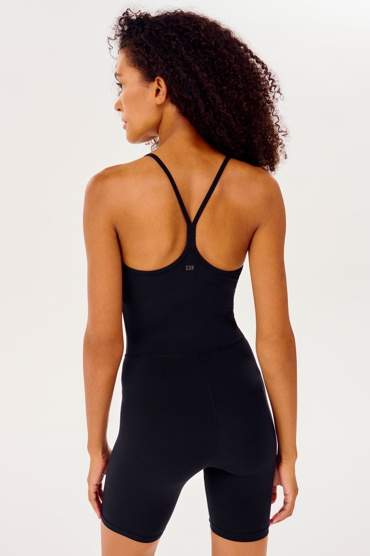 Half back view of black mid thigh spaghetti strap body suit/one piece