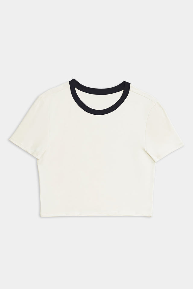 White SPLITS59 Airweight S/S Crop with black neckline detailing on a plain background.