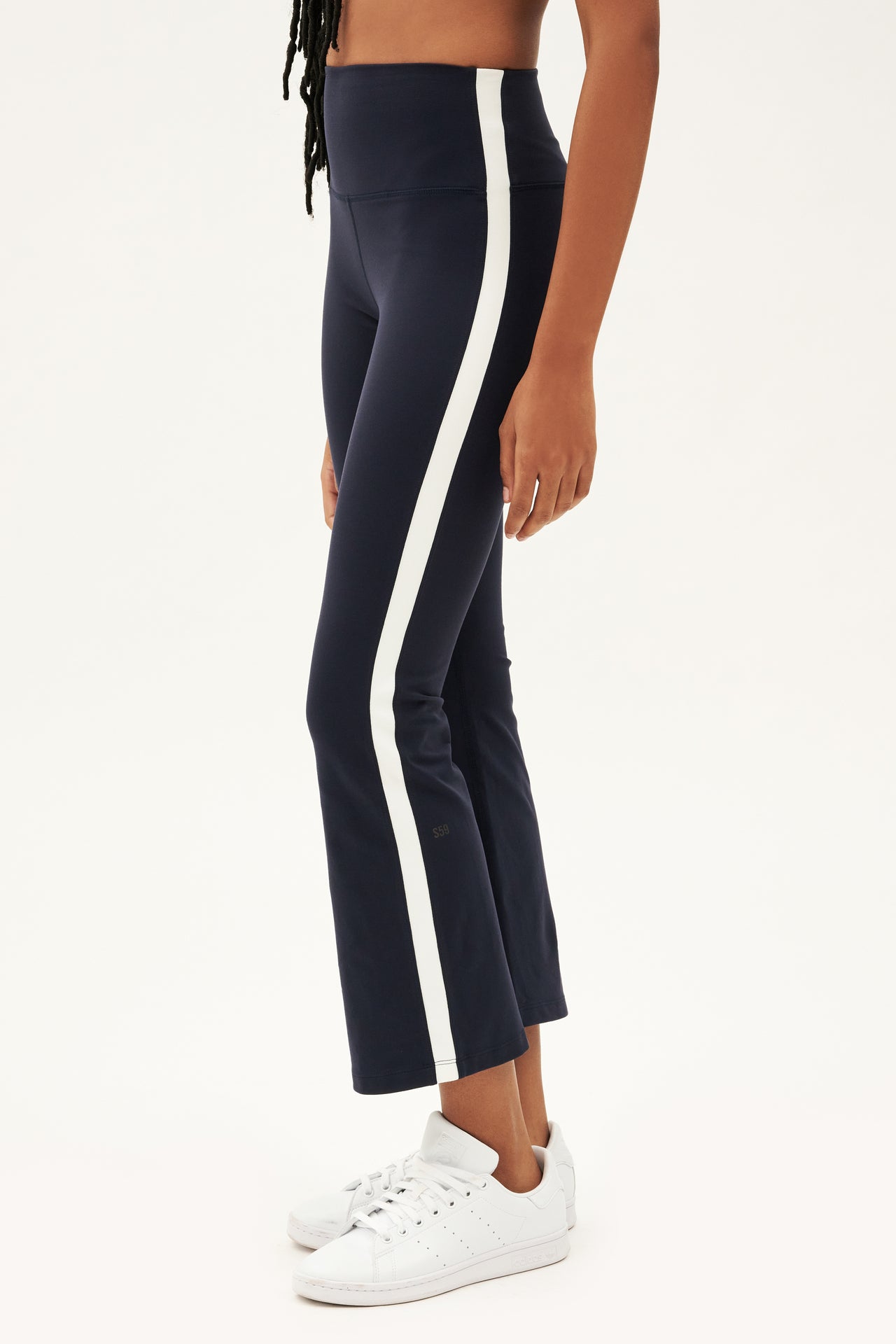 A woman wearing high waist Raquel navy and white stripe leggings made from 4-way stretch supplex fabric. 
Product Name: SPLITS59 Raquel High Waist Crop - Indigo/White