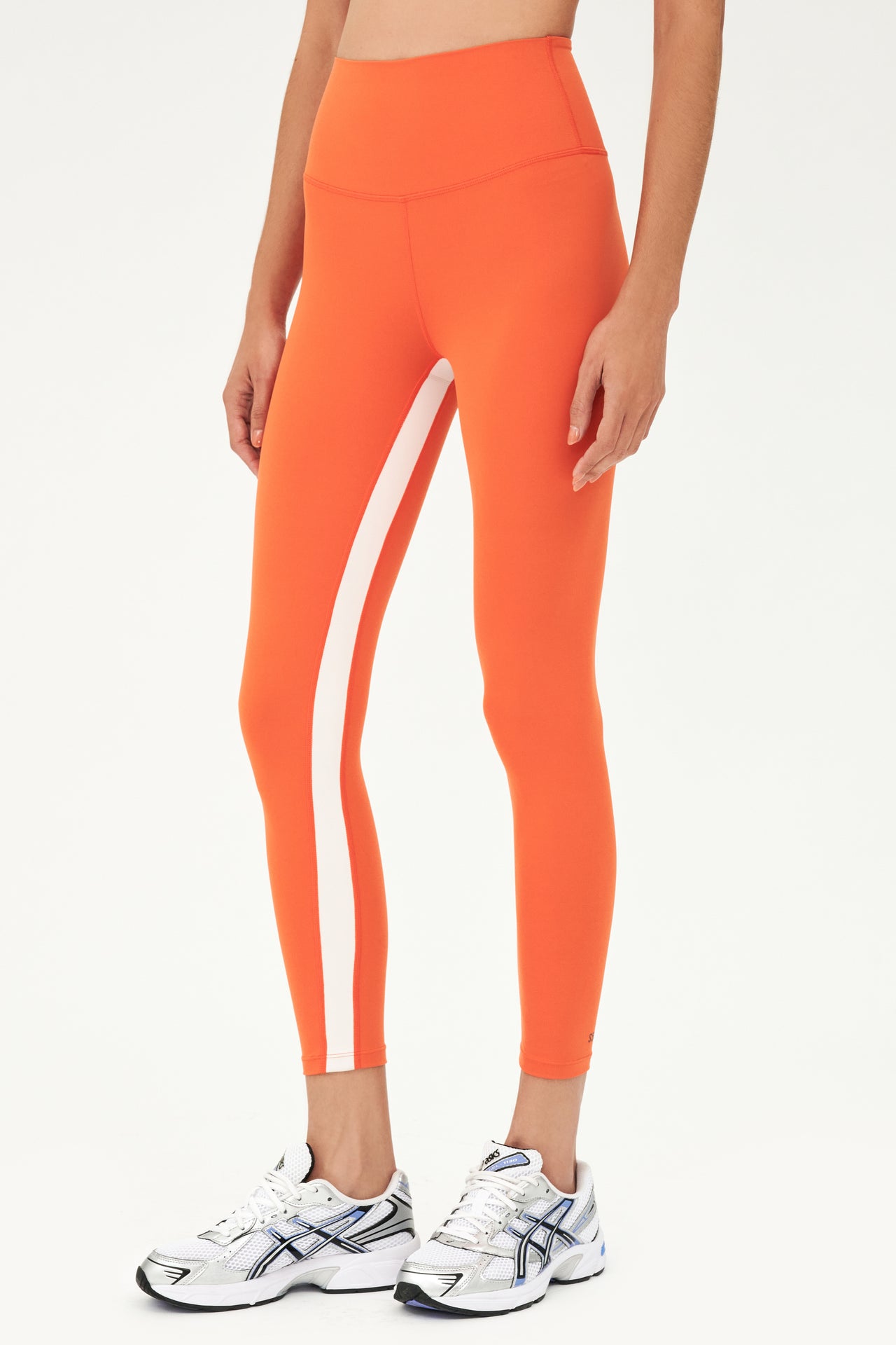 Half body, side, shot of woman in orange tights with white stripe on inseam