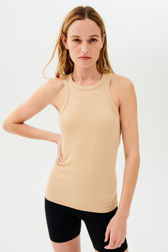 The model is wearing a SPLITS59 Kiki Rib Tank Full Length - Nude suitable for gym workouts.