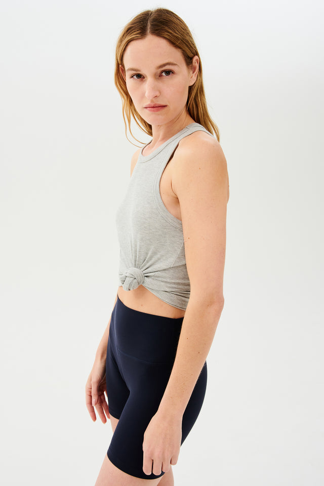 The model is wearing a SPLITS59 Kiki Rib Tank Full Length in Heather Grey for gym workouts and black shorts.