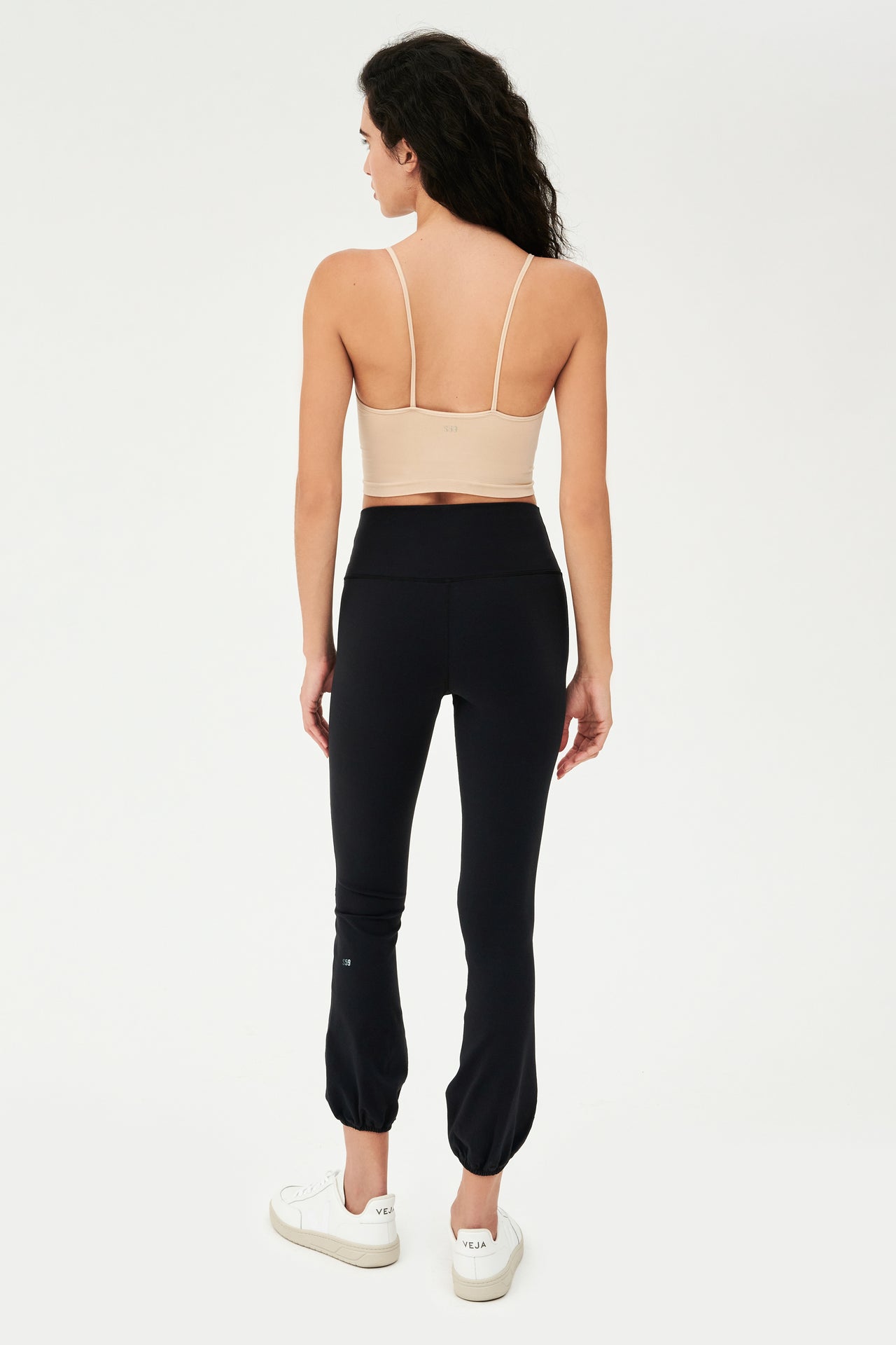 The back view of a woman wearing SPLITS59's Icon High Waist Supplex Legging in Black.