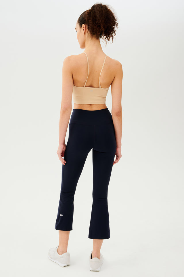 The back view of a woman wearing Raquel High Waist Crop - Indigo leggings crafted from high waist 4-way stretch fabric, perfect for gym workouts by SPLITS59.