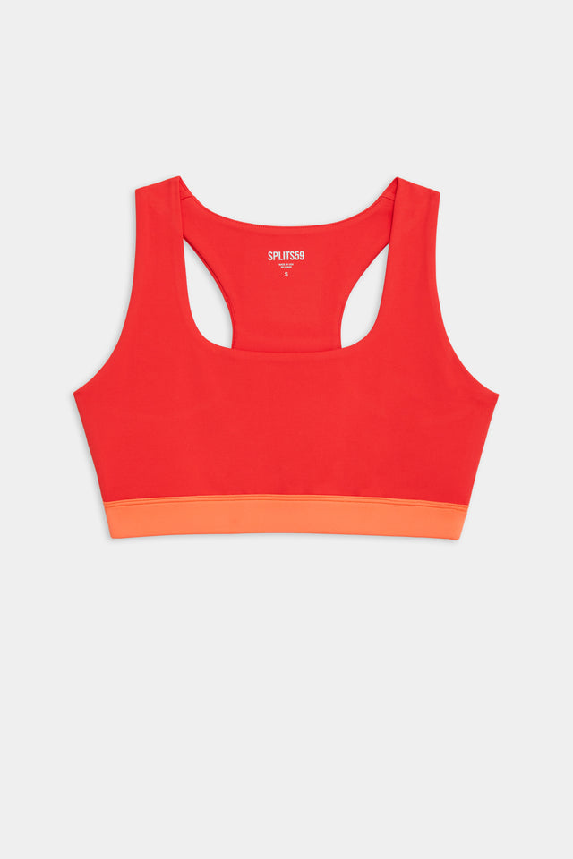 Flat view of red sports bra with orange band around ribs