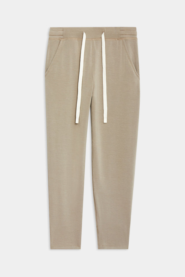 Front flat view of  light brown creme tone crewneck sweatshirt and sweatpant with tapered leg and above ankle length with white drawstring side hip pockets